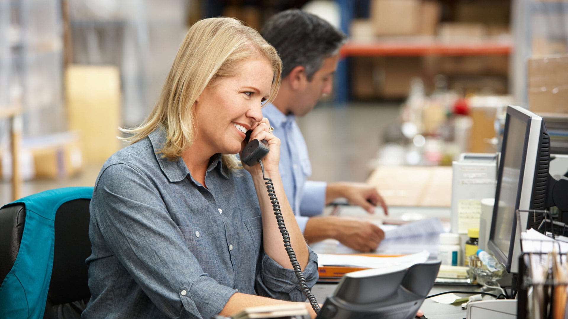 Woman working at desk in warehouse