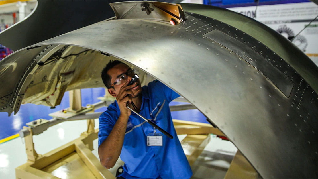 A man inspects an aircraft component