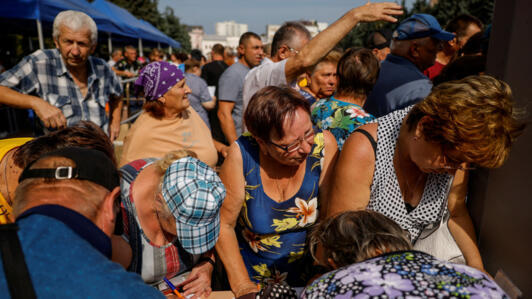 People queue at a humanitarian aid distribution center for residents, who were evacuated from Russia's Kursk region following an incursion of Ukrainian troops.