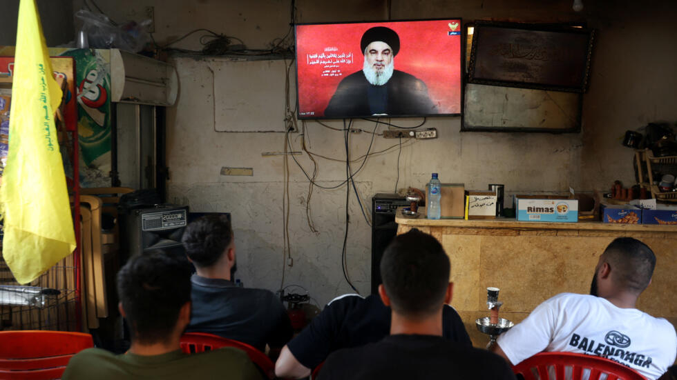 People watch Hezbollah chief Hassan Nasrallah delivering a televised address from a cafe in Sidon, Lebanon September 19, 2024.