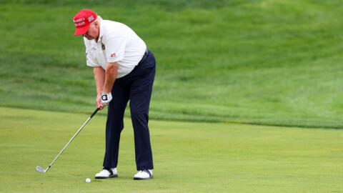 Former US president Donald Trump hits his shot from the first fairway during the pro-am prior to the LIV Golf Invitational at Trump National Golf Club on August 10, 2023.