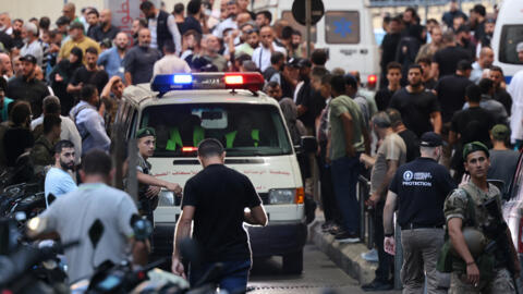 Ambulances are surrounded by people at the entrance of the American University of Beirut Medical Centre, on 17 September, 2024, after explosions hit locations in several Hezbollah strongholds around Lebanon.