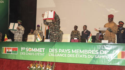 The leaders of Mali, Niger and Burkina Faso (L-R), Colonel Assimi Goita, General Abdourahamane Tiani and Captain Ibrahim Traore, showing the documents of the Confederation of Sahel States (AES) which they signed during their first summit in in July. Goita announced Sunday that the alliance will soon be issuing its own passports.