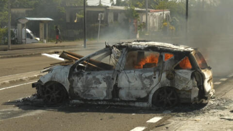 A car burning in a street of Fort-de-France, Martinique, following a night of riots amid protests over the high cost of living on the island, 17 September 2024.