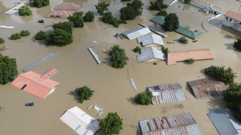 This aerial view shows houses submerged under water in Maiduguri on 10 September 2024.