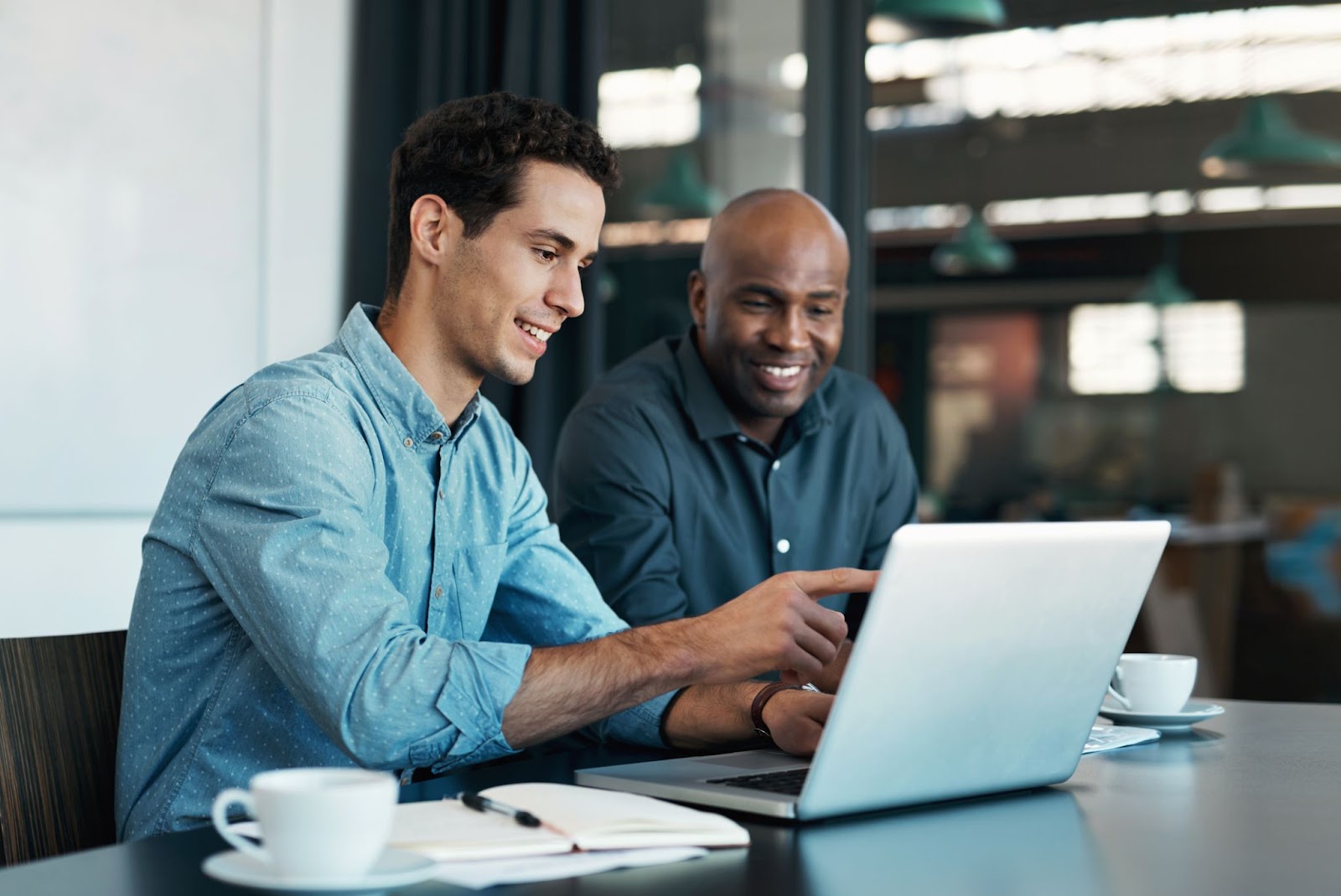 An image of two business professionals who could be using a tool like Duet AI on their laptop