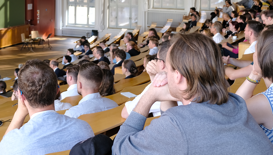 Photo. Full rows of people in the lecture hall.