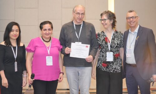 Photo. Prof. Franz Baader and Prof. Renata Wassermann receiving the best paper award at KR2024.