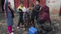 A health worker administers a polio vaccine to a child in Pakistan in December 2024.