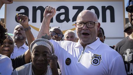 FILE - Teamsters General President Sean M. O'Brien, center, rallies with Amazon workers outside the Staten Island Amazon facility JFK8, June 19, 2024, in New York.