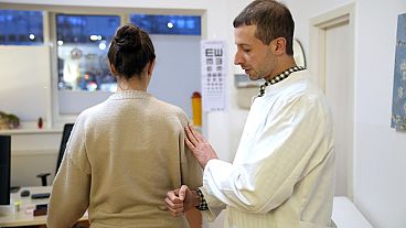 Dr Ayham Darouich examines a patient in Berlin, Germany, in December 2024.