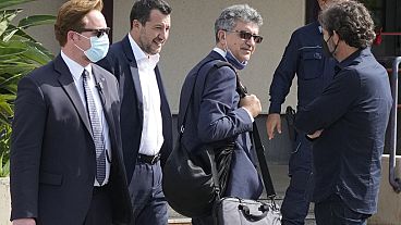 Former minister of interior Matteo Salvini, second from left, walks past Open Arms founder Oscar Camps, right, outside Palermo's court, Italy, Saturday, Oct. 23, 2021. 