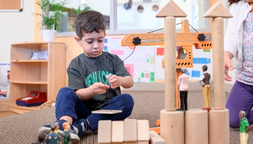 boy experimenting with learning toys