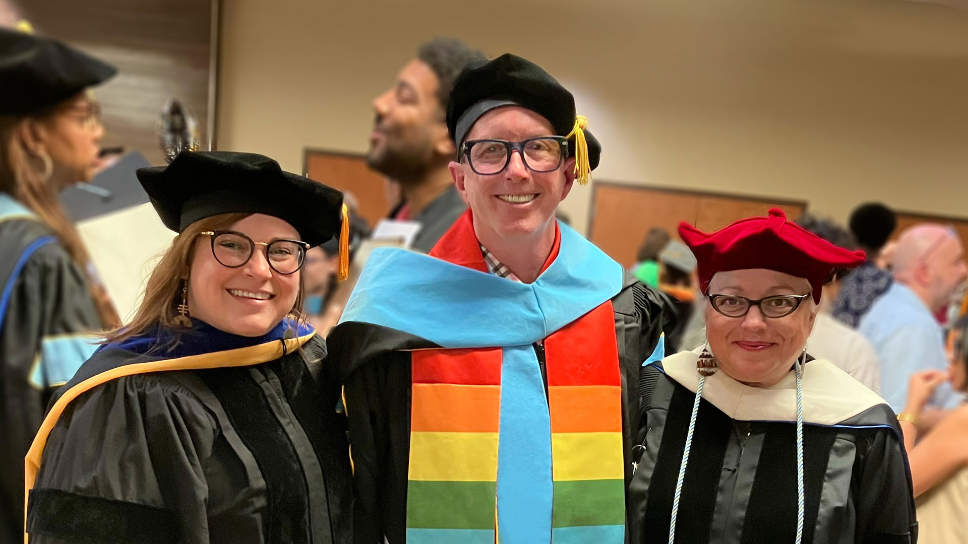 Vice, middle, poses at commencement with two of his colleagues.