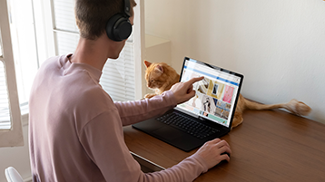 A man using Surface laptop on a desk