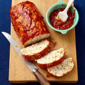 Slow Cooker Turkey Vegetable Meatloaf displayed on wood cutting board