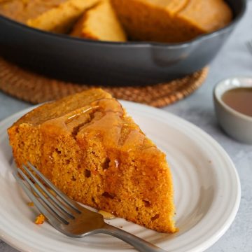 Close up of slice of sweet potato cornbread with honey drizzle.