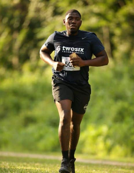 Man Running with Two Six Technologies Shirt