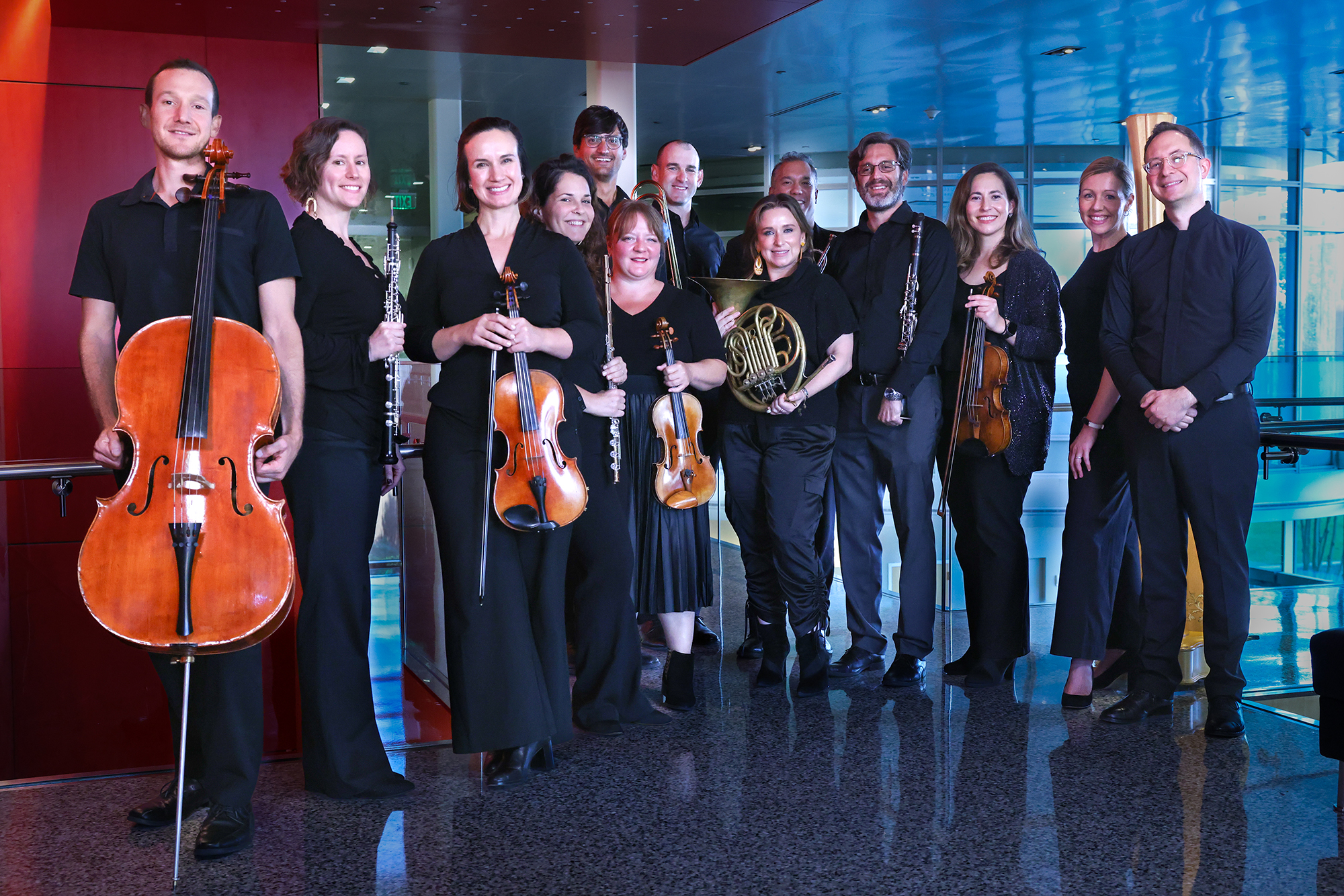 A group of musicians pose, some holding instruments