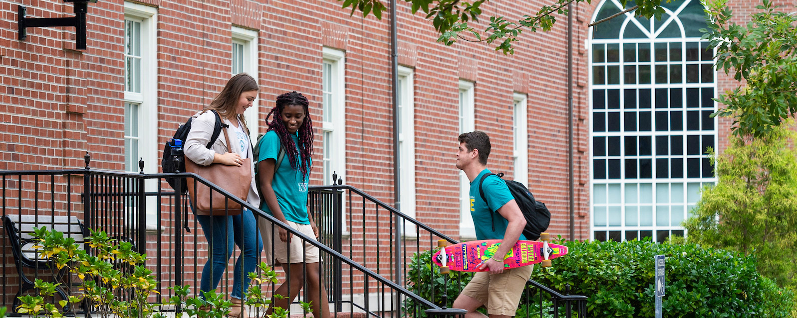 Students sit in the connector overlooking chancellor's walk