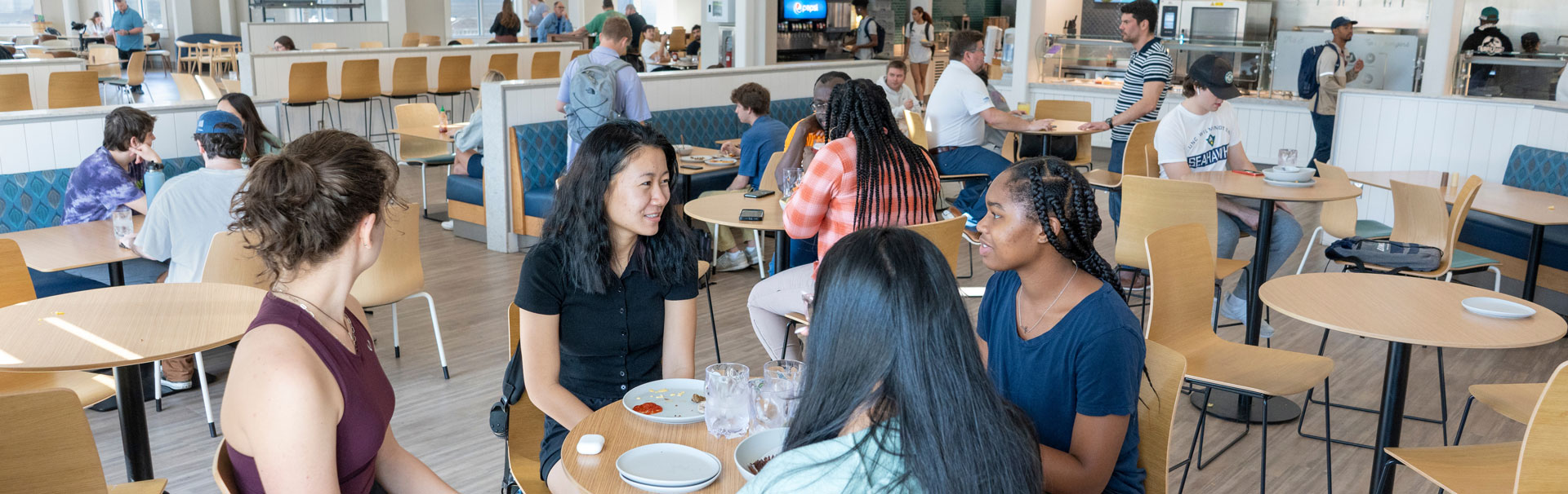 groups of students sitting at a table eating at the Shore Dining hall