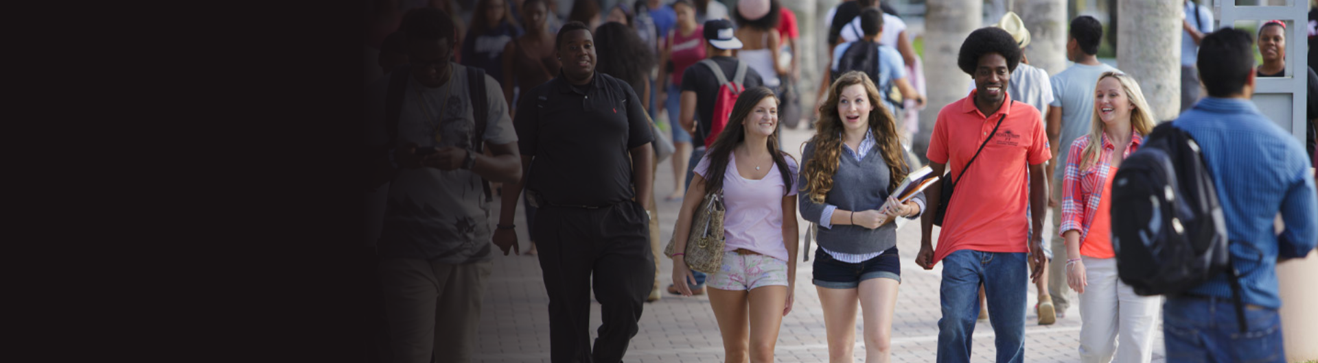 a group of students wearing backpacks and carrying books walking together