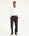 Front view of model wearing Black Easy Khakis, Pleated, Classic Fit.