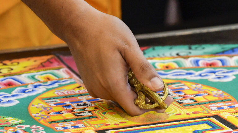 Tibetan Monks work on a sacred sand mandala at the USC Asian Pacific Museum.