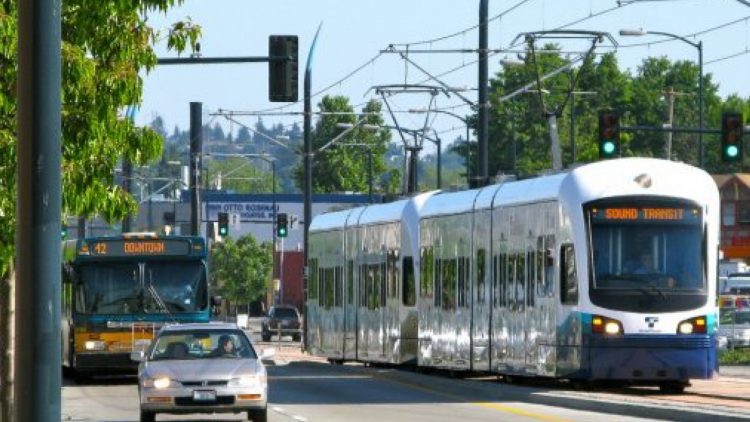 Stoplight with car and Sounder train.