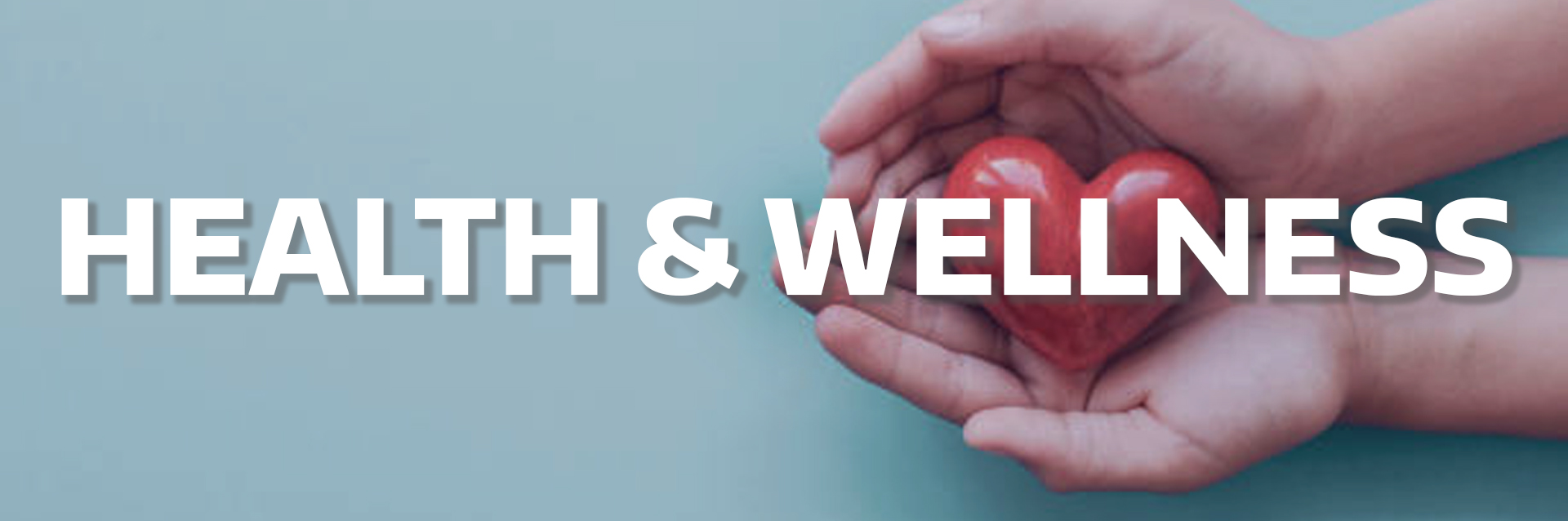 Photo of a person holding a clay heart with text: Health & Wellness