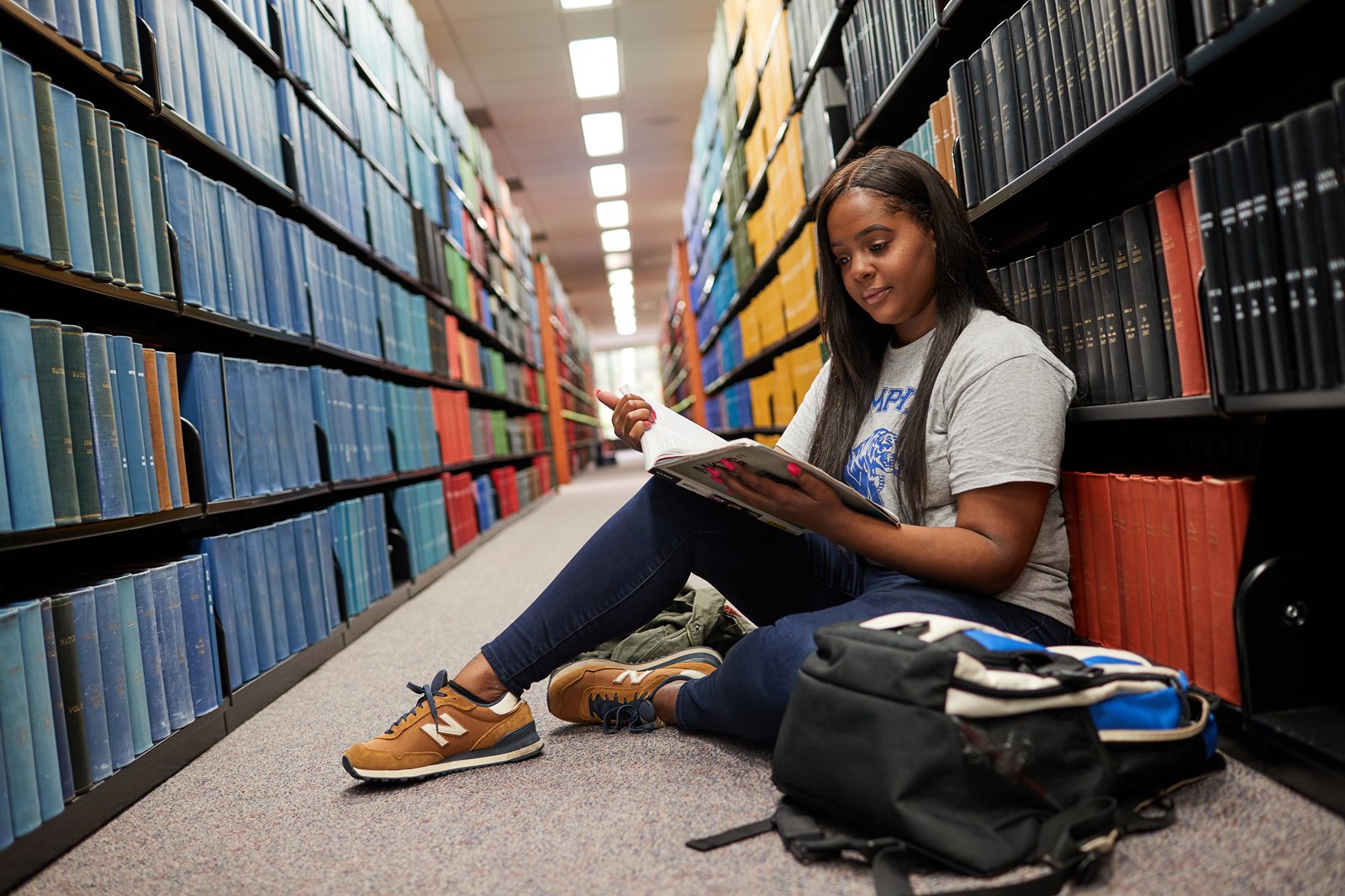 Student reading in library