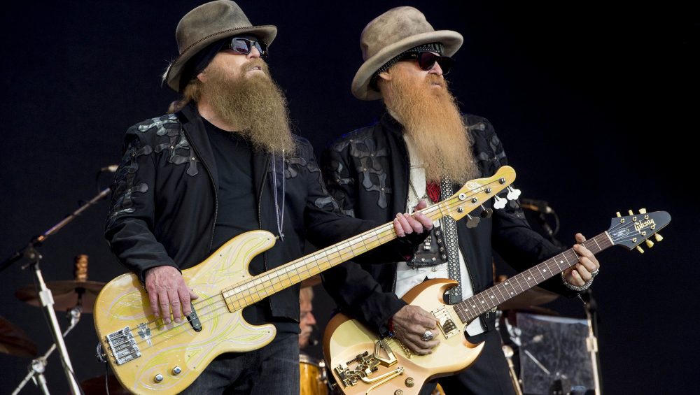 dead dies appreciation - Dusty Hill, left, and Billy Gibbons from U.S rock band ZZ Top perform at the Glastonbury music festival in Somerset, England, June 24, 2016. ZZ Top has announced that Hill, one of the Texas blues trio's bearded figures and bassist, has died at his Houston home. He was 72. In a Facebook post, bandmates Billy Gibbons and Frank Beard revealed Wednesday, July 28, 2021, that Hill had died in his sleep. (Photo by Jonathan Short/Invision/AP, File)