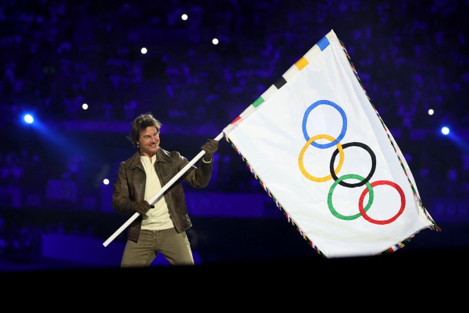 PARIS, FRANCE - AUGUST 11: Actor Tom Cruise holds the Olympic flag during the Closing Ceremony of the Olympic Games Paris 2024  at Stade de France on August 11, 2024 in Paris, France. (Photo by Fabrizio Bensch- Pool/Getty Images)