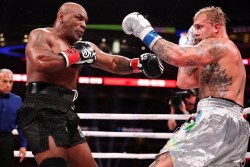 ARLINGTON, TEXAS - NOVEMBER 15: (L-R) Mike Tyson and Jake Paul fight during LIVE On Netflix: Jake Paul vs. Mike Tyson at AT&T Stadium on November 15, 2024 in Arlington, Texas. (Photo by Al Bello/Getty Images for Netflix © 2024)