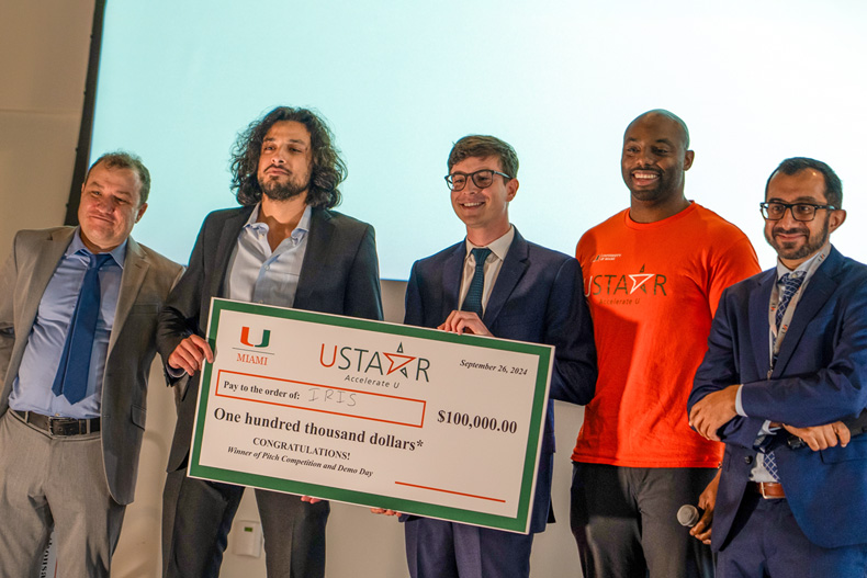 From left, Ilmar Tamames, associate director of USTAAR, celebrates with Mustafa Abdel-Mottaleb and Aaron Fils who won $100,000 for their business, IRIS Analytics, along with USTAAR associate director, Darien Smith, and USTAAR director professor Suhrud Rajguru. Photo: Matthew Rembold/University of Miami.