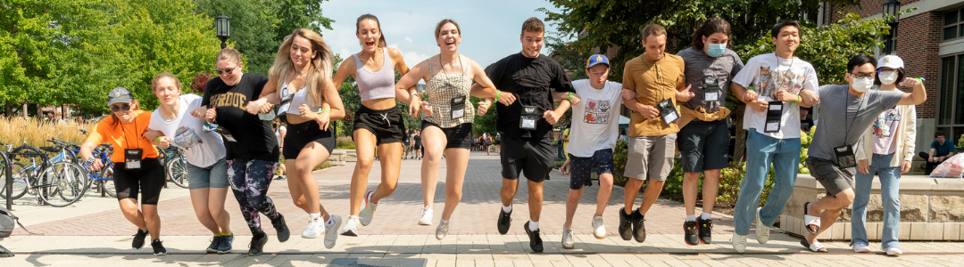 students jumping over train tracks at BGR