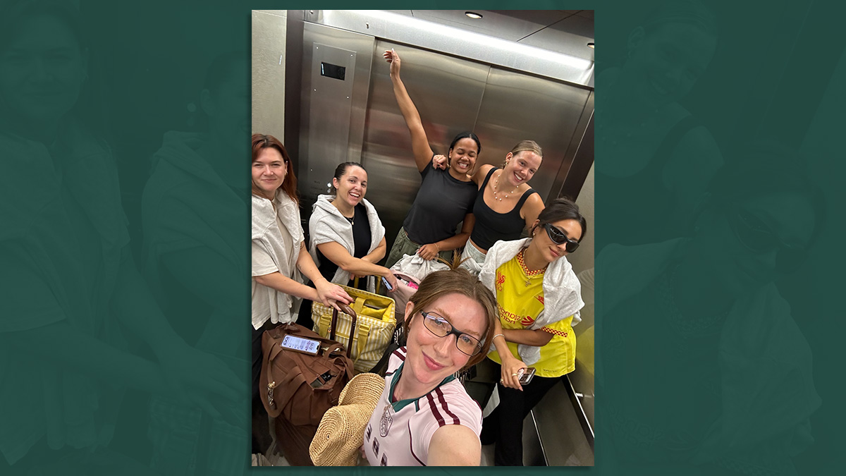 group of people in an elevator taking a picture