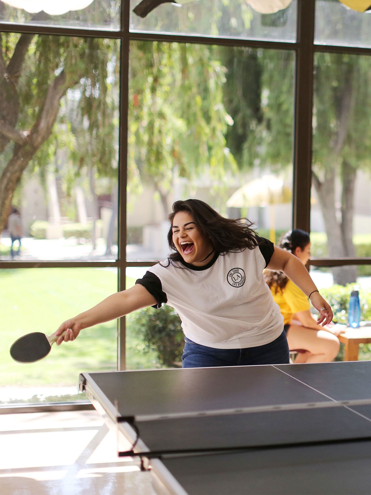 A student playing ping pong.