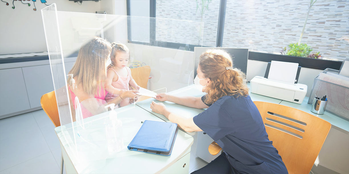 Healthcare provider seeing a young patient in doctor's office