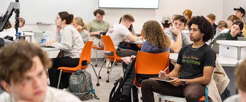 Students in a classroom taking notes