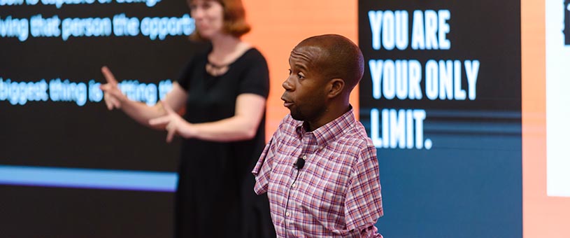 Person with limb differences speaking at an NDEAM event