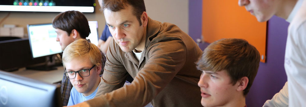 A Cybersecurity instructor working with students