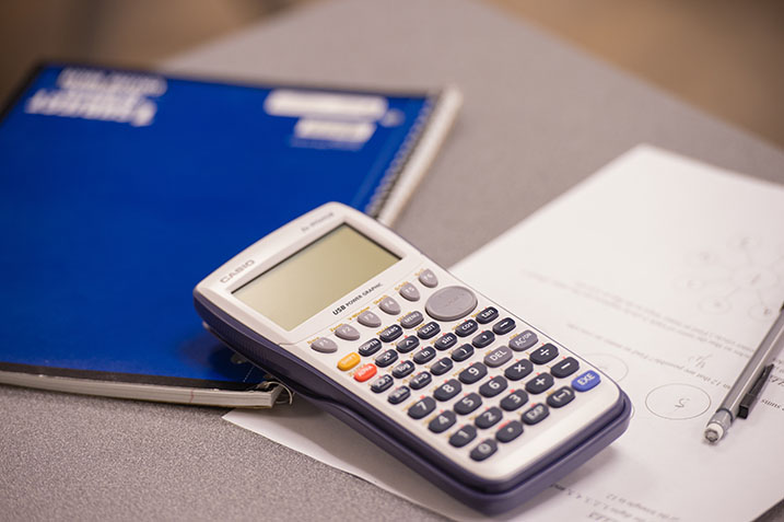 Calculator with a notebook and pencil.