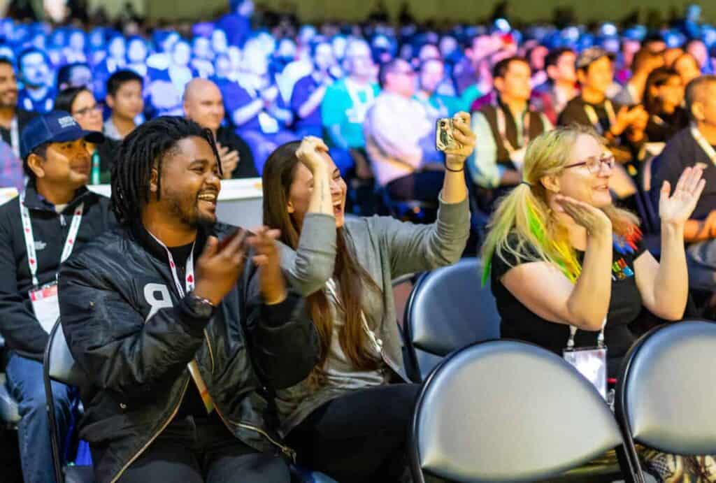 Participants cheering at a conference