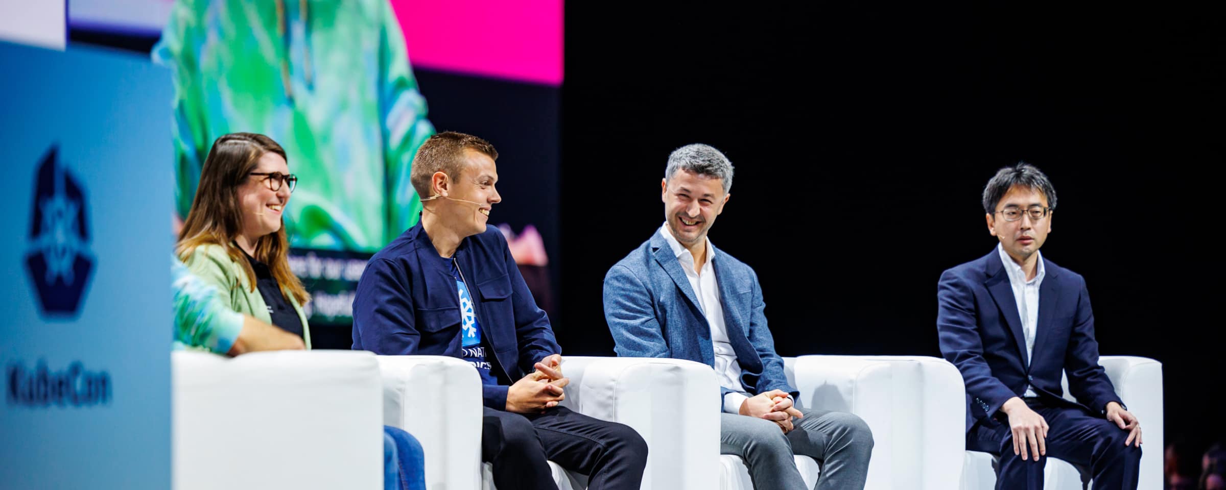 Panelists on stage at a conference