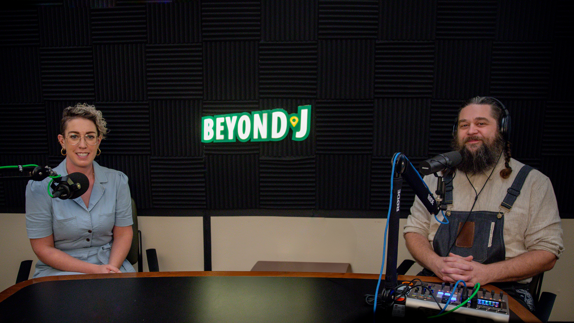 Erin Kaplan and Phillip Altstatt sitting at a table in the Beyond J recording studio.