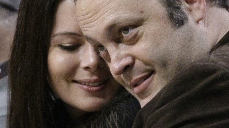 Vince Vaughn sits courtside with his wife Kyla Weber during the second half of an NBA basketball game between the Chicago Bulls and the Philadelphia 76ers, Saturday, Feb. 20, 2010, in Chicago. (AP / Charles Rex Arbogast)