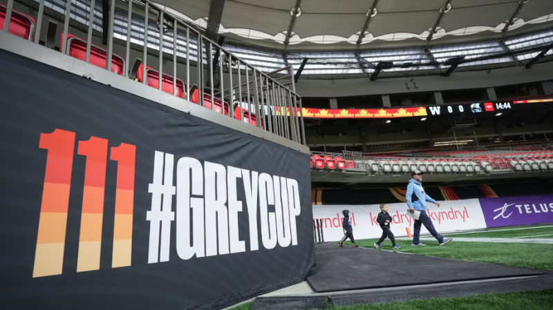 Argonauts head coach Ryan Dinwiddie walks onto the field for football practice with his sons Cannon and Lancen, ahead of the 111th CFL Grey Cup in Vancouver, on Wednesday, November 13, 2024. THE CANADIAN PRESS/Darryl Dyck