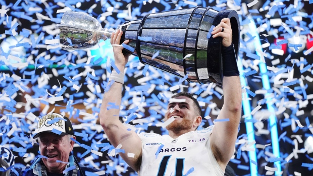 Toronto Argonauts quarterback Nick Arbuckle (4) lifts the Grey Cup after defeating the Winnipeg Blue Bombers in CFL football action at the 111th Grey Cup in Vancouver on Sunday, November 17, 2024. THE CANADIAN PRESS/Darryl Dyck