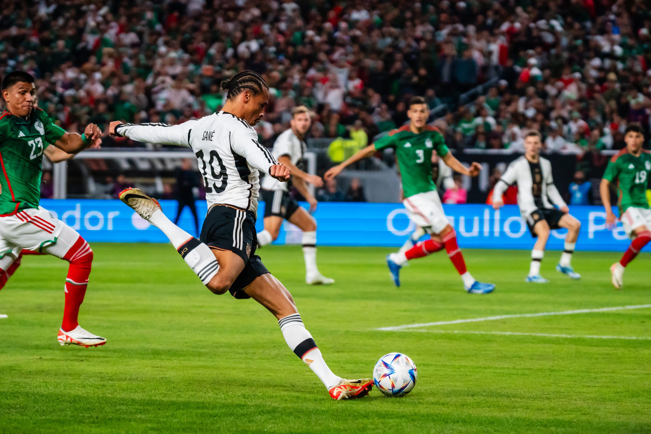 A professional soccer player kicks a ball.